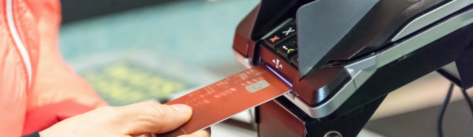 a person place their card in a payment machine