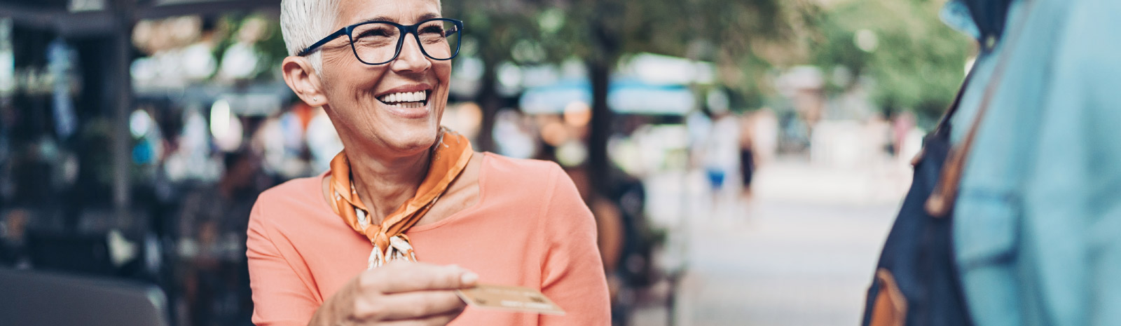 Mature woman pays for lunch.